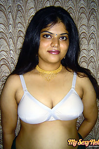 Gorgeous Neha Nair in white bra giving seductive poses and playing with bigtits