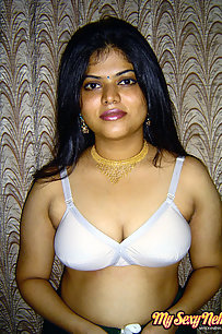 Gorgeous Neha Nair in white bra giving seductive poses and playing with bigtits